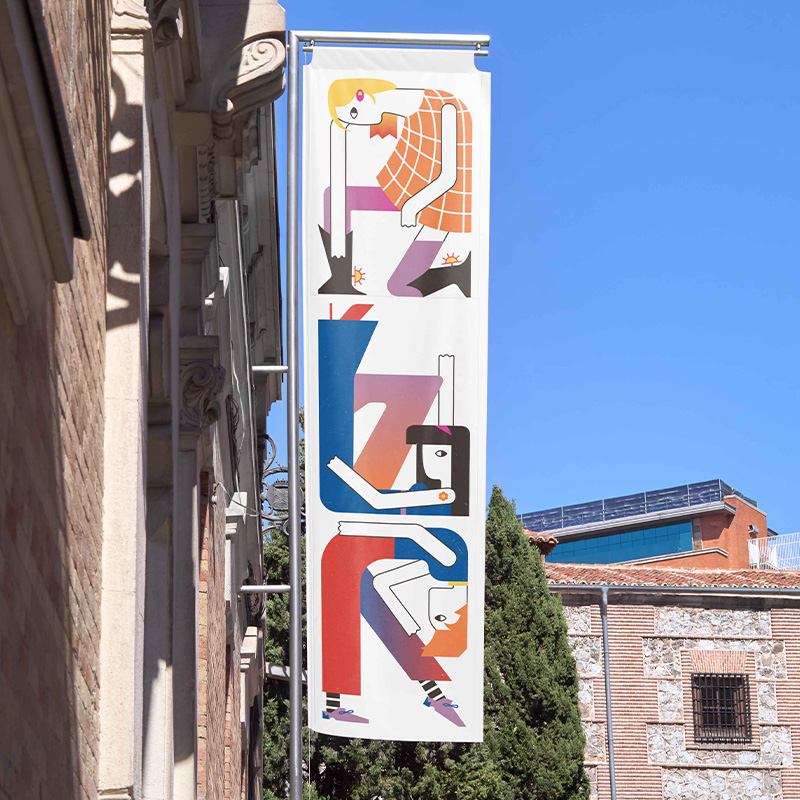 A banner on the side of a building featuring three illustrated figures in anatomically incorrect poses